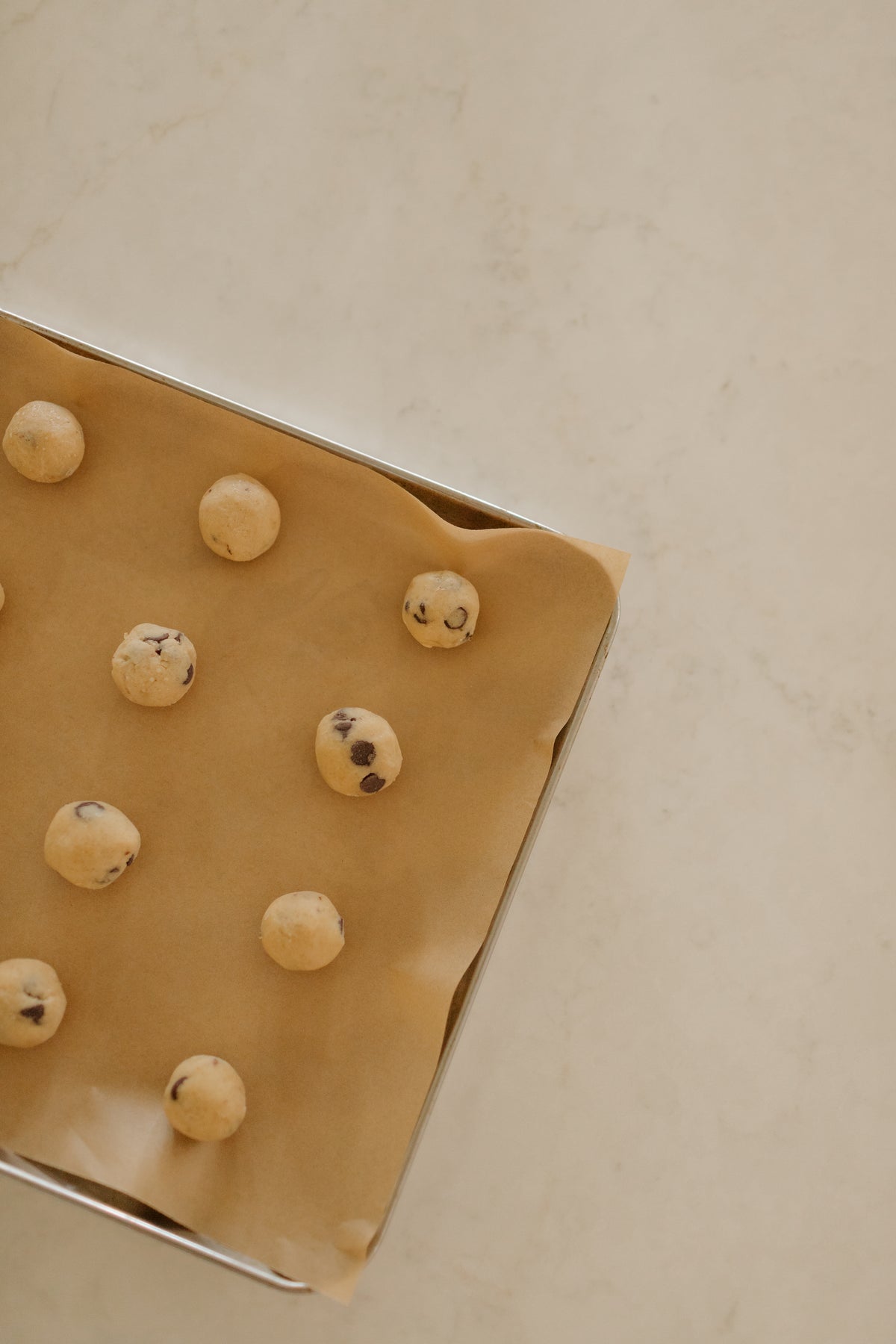 The dough balls on the tray from above