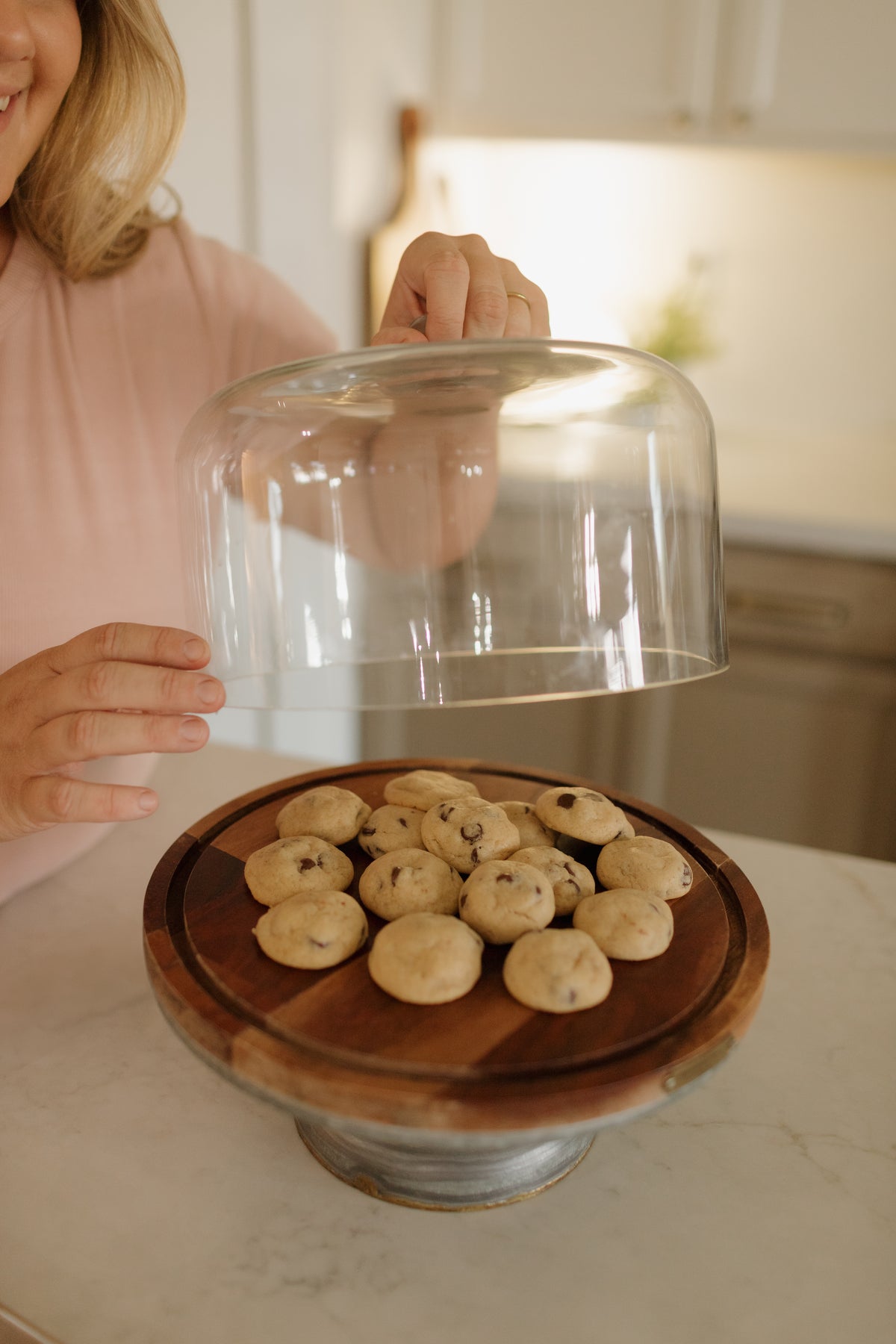 Fresh cookies under a glass cake dome