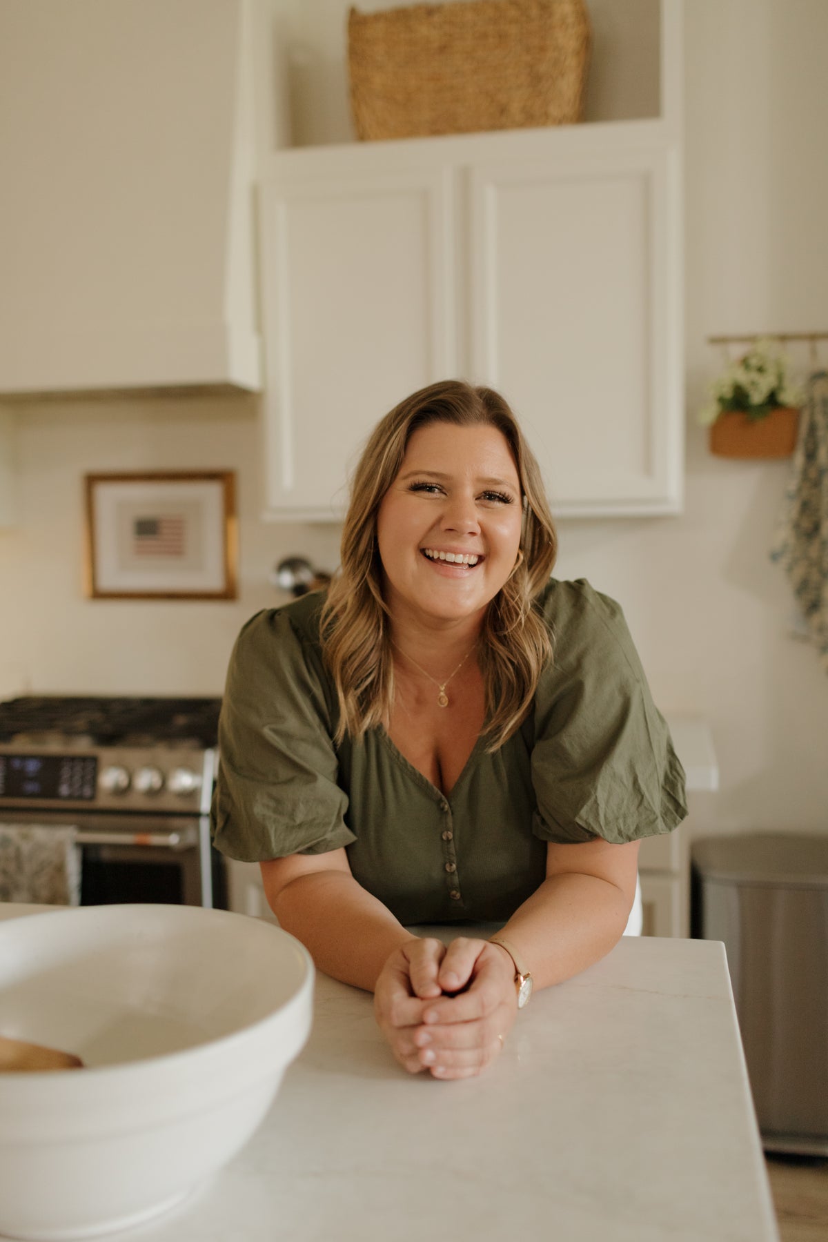Abbie Flake laughing in her farmhouse kitchen
