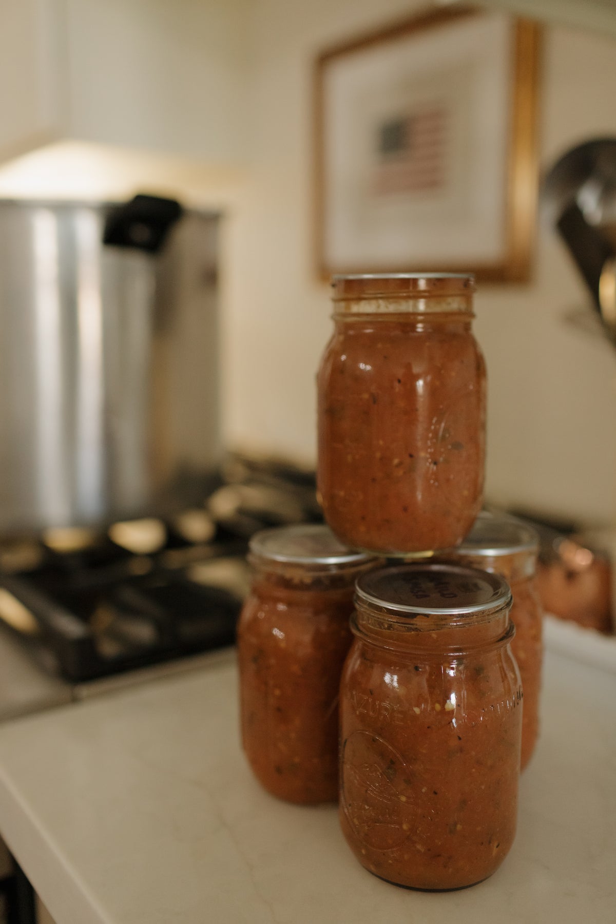 Home-canned tomato sauce in mason jars on Abbie's stove