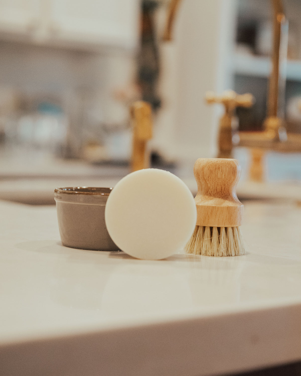 Hands whisking in a cream ceramic crock on the kitchen counter